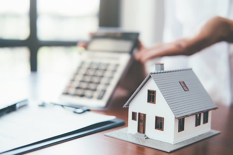 House model with real estate agent and customer discussing for c